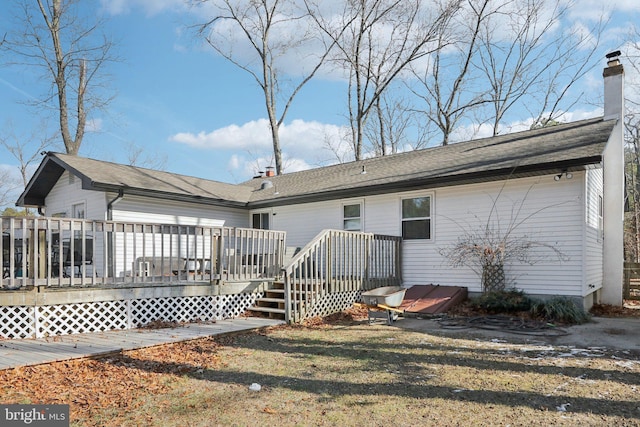 rear view of house featuring a wooden deck