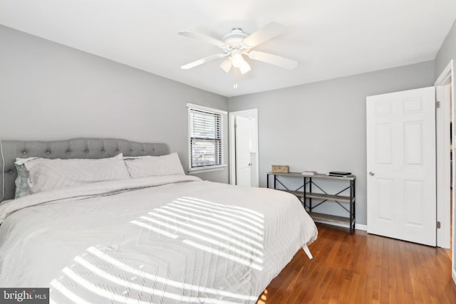 bedroom featuring dark hardwood / wood-style floors and ceiling fan