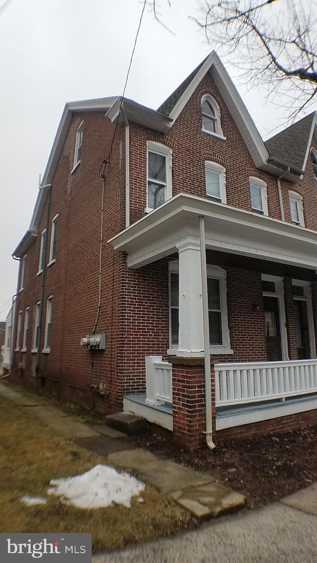 view of property exterior with covered porch