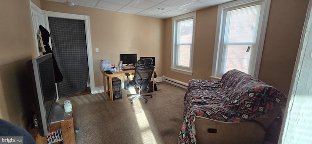 office area featuring a paneled ceiling and a baseboard radiator