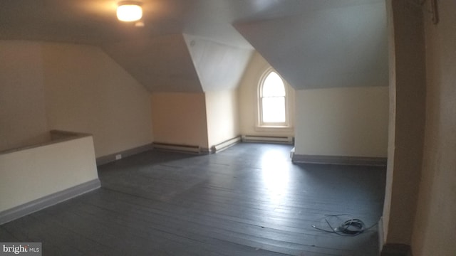 bonus room with dark hardwood / wood-style flooring and vaulted ceiling