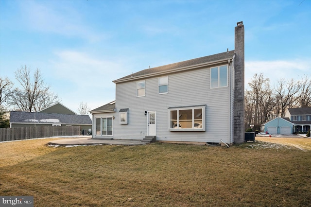 rear view of property with a yard, a patio area, and central AC