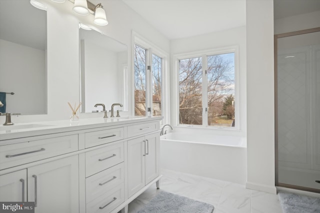 bathroom featuring vanity, separate shower and tub, and a wealth of natural light