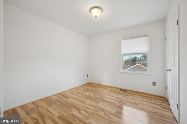 unfurnished room with light wood-type flooring