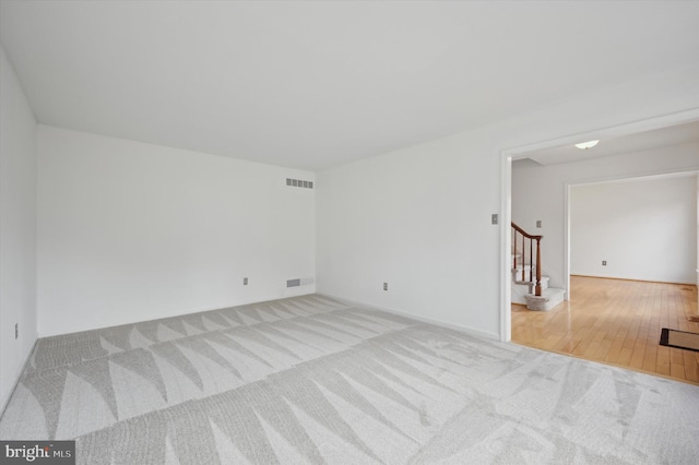 unfurnished room with light carpet