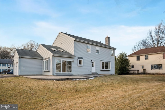 rear view of property featuring a yard and a patio area