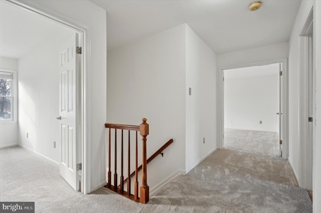 hall with light colored carpet