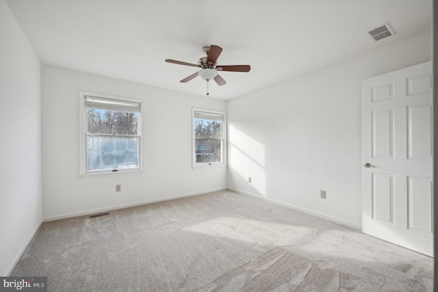 carpeted spare room with ceiling fan