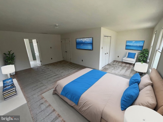 bedroom featuring multiple closets and light colored carpet