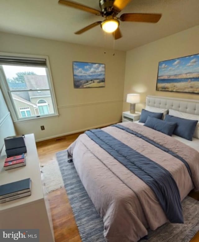 bedroom featuring hardwood / wood-style floors and ceiling fan