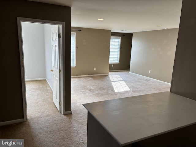 unfurnished room with light carpet, baseboards, and recessed lighting