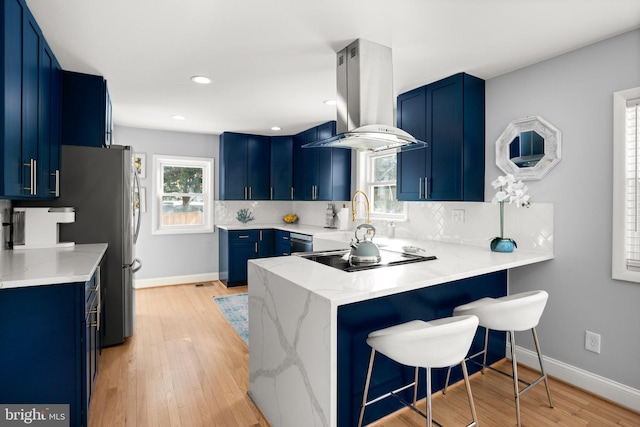 kitchen with blue cabinets, island exhaust hood, black appliances, and kitchen peninsula