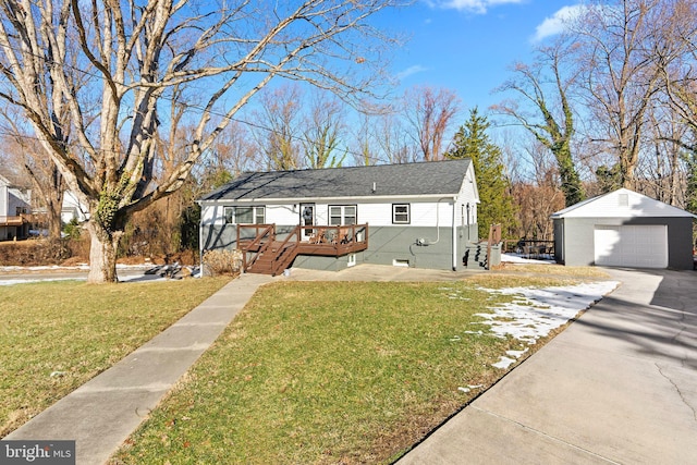 bungalow featuring an outbuilding, a wooden deck, a garage, and a front lawn