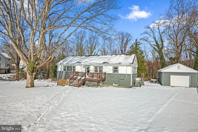 view of front of house with an outbuilding, a garage, and a wooden deck