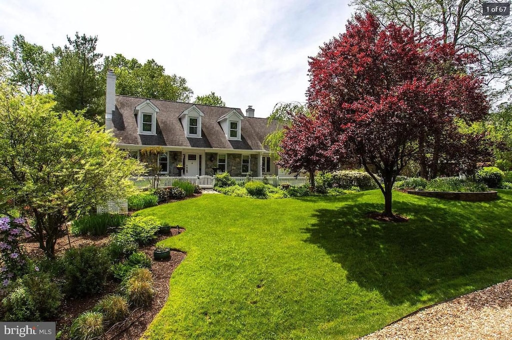 cape cod-style house with a porch and a front yard