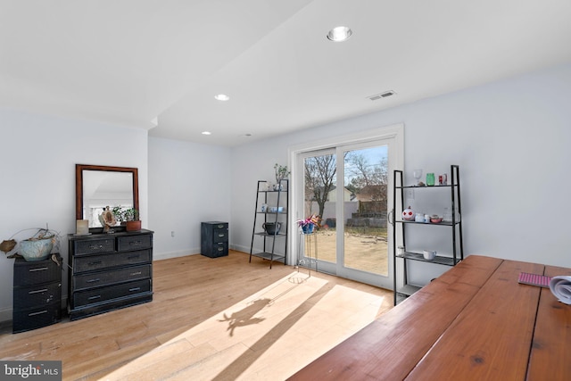 bedroom featuring access to exterior and light wood-type flooring