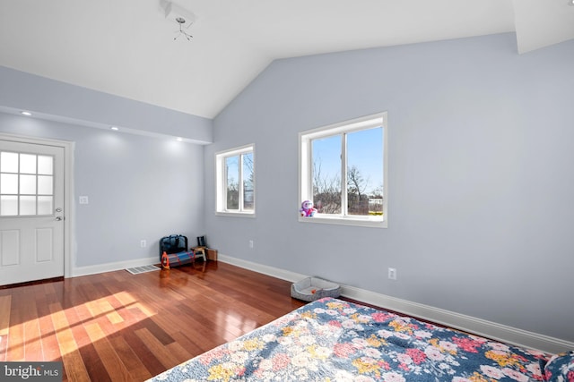 bedroom with lofted ceiling and hardwood / wood-style floors