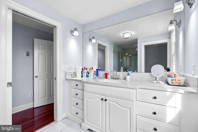 bathroom featuring vanity, a shower with shower door, and tile patterned flooring