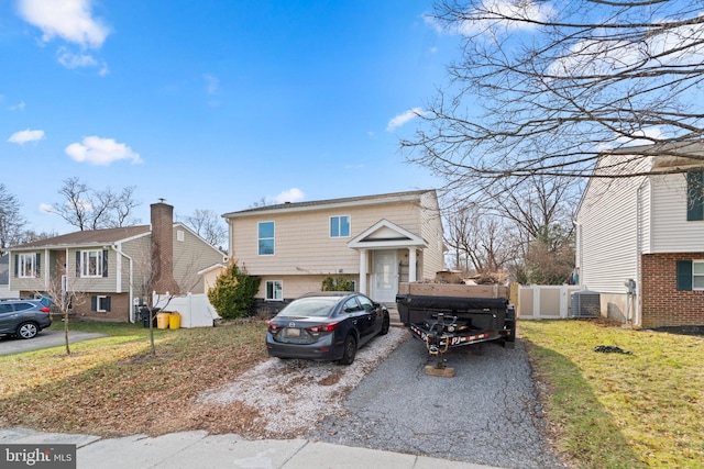 raised ranch with a front lawn