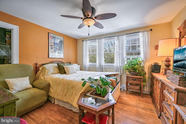 bedroom with light wood-style flooring and ceiling fan