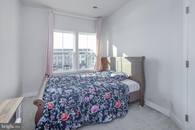 bedroom featuring light colored carpet