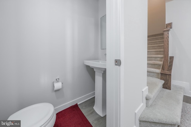 bathroom with sink, wood-type flooring, and toilet