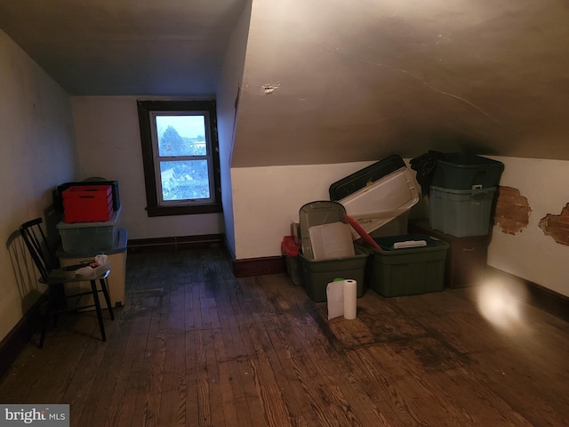 bonus room featuring dark wood-type flooring and lofted ceiling