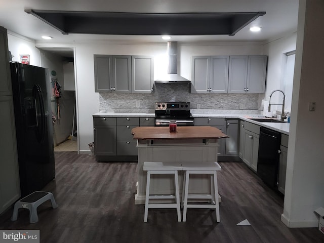 kitchen featuring wall chimney range hood, gray cabinets, sink, and black appliances