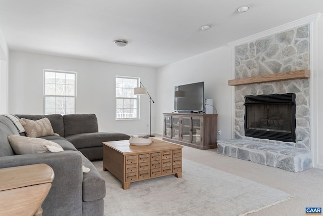 living room featuring a stone fireplace and light colored carpet