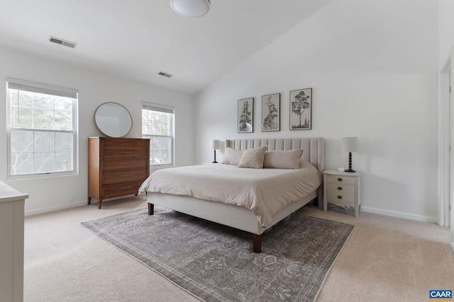 carpeted bedroom with lofted ceiling