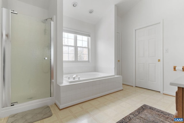 bathroom featuring shower with separate bathtub