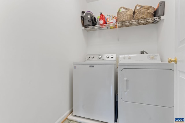 clothes washing area featuring separate washer and dryer