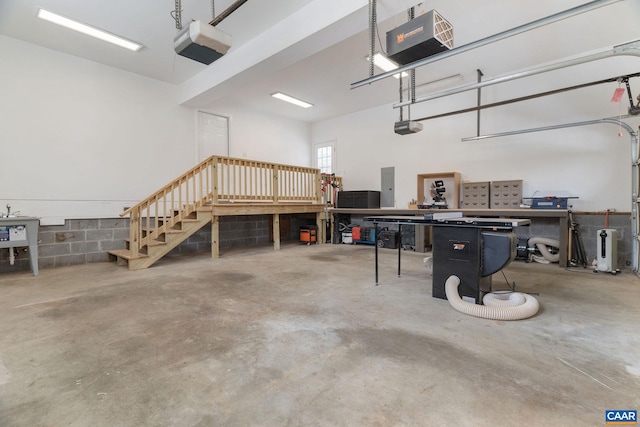 garage featuring a garage door opener and a workshop area