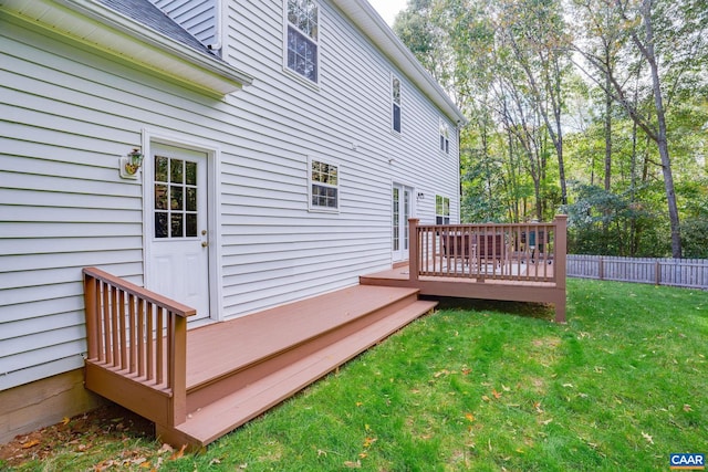 wooden deck featuring a lawn