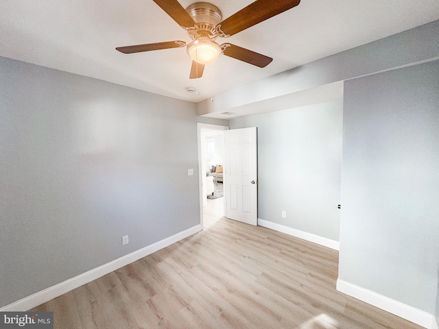 empty room with ceiling fan and light hardwood / wood-style floors