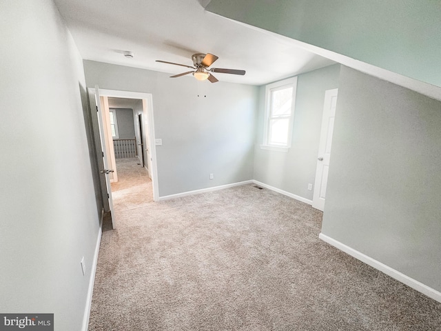 interior space with carpet floors and ceiling fan