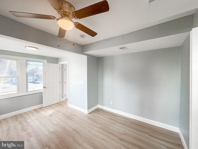 empty room with ceiling fan and light wood-type flooring