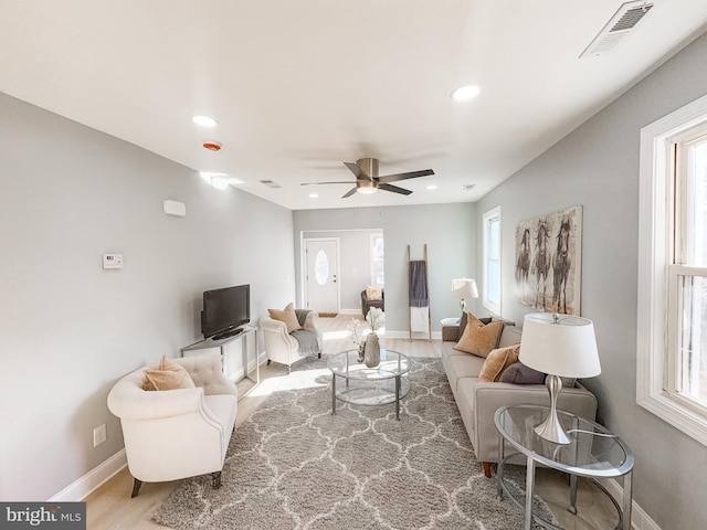 living room featuring ceiling fan and light wood-type flooring