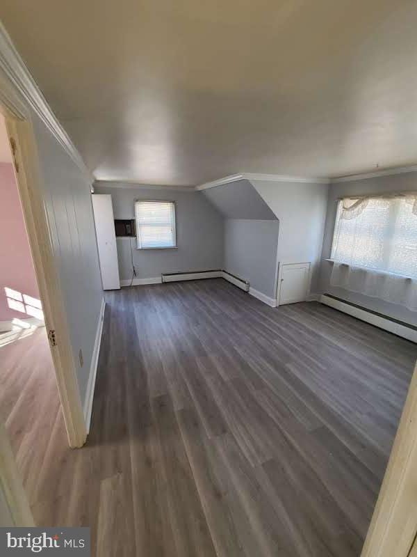 bonus room featuring vaulted ceiling, dark hardwood / wood-style floors, and baseboard heating