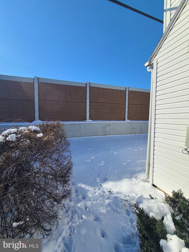 view of yard layered in snow