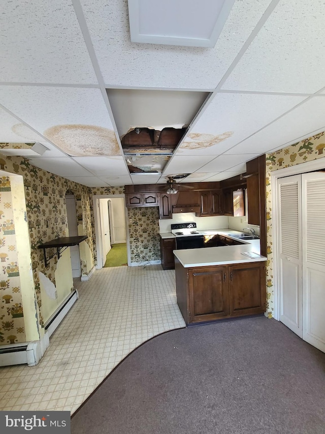 kitchen featuring sink, baseboard heating, dark brown cabinets, range with electric cooktop, and a drop ceiling