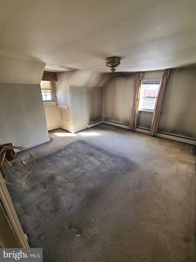 bonus room with vaulted ceiling, carpet, and a healthy amount of sunlight