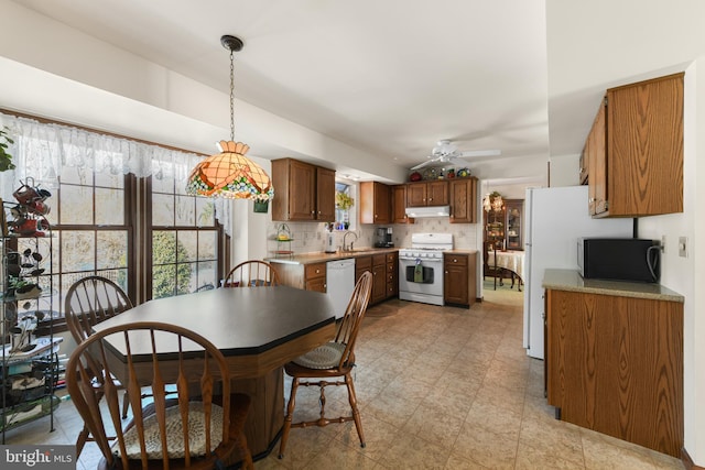 dining room with light floors and ceiling fan