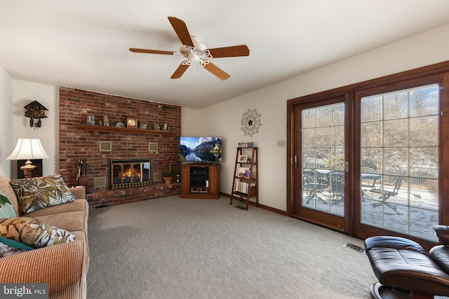 living room with visible vents, a ceiling fan, a fireplace, carpet flooring, and vaulted ceiling