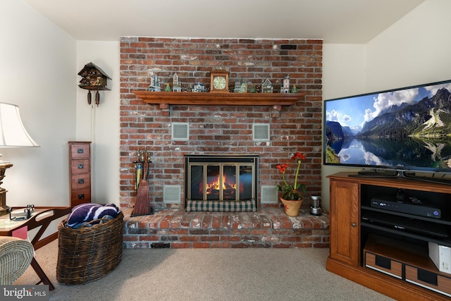 carpeted living area with visible vents and a fireplace