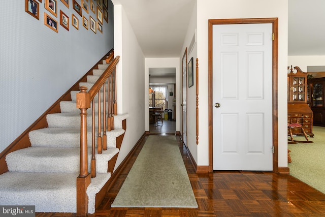 foyer with stairs and baseboards