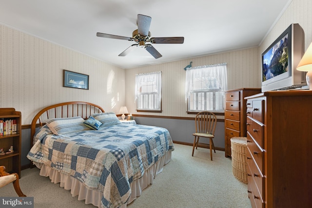 bedroom with wallpapered walls, a ceiling fan, baseboards, and light carpet