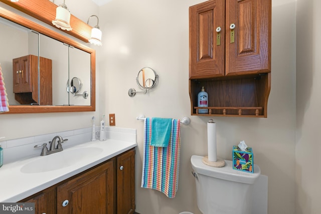 bathroom with toilet and vanity