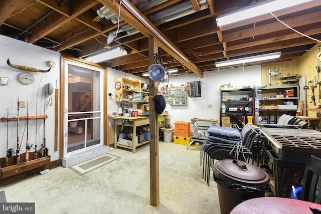 unfinished basement with a workshop area