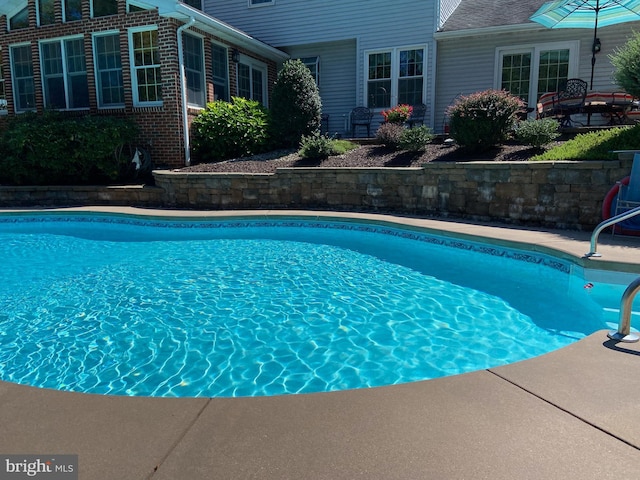 outdoor pool with a patio